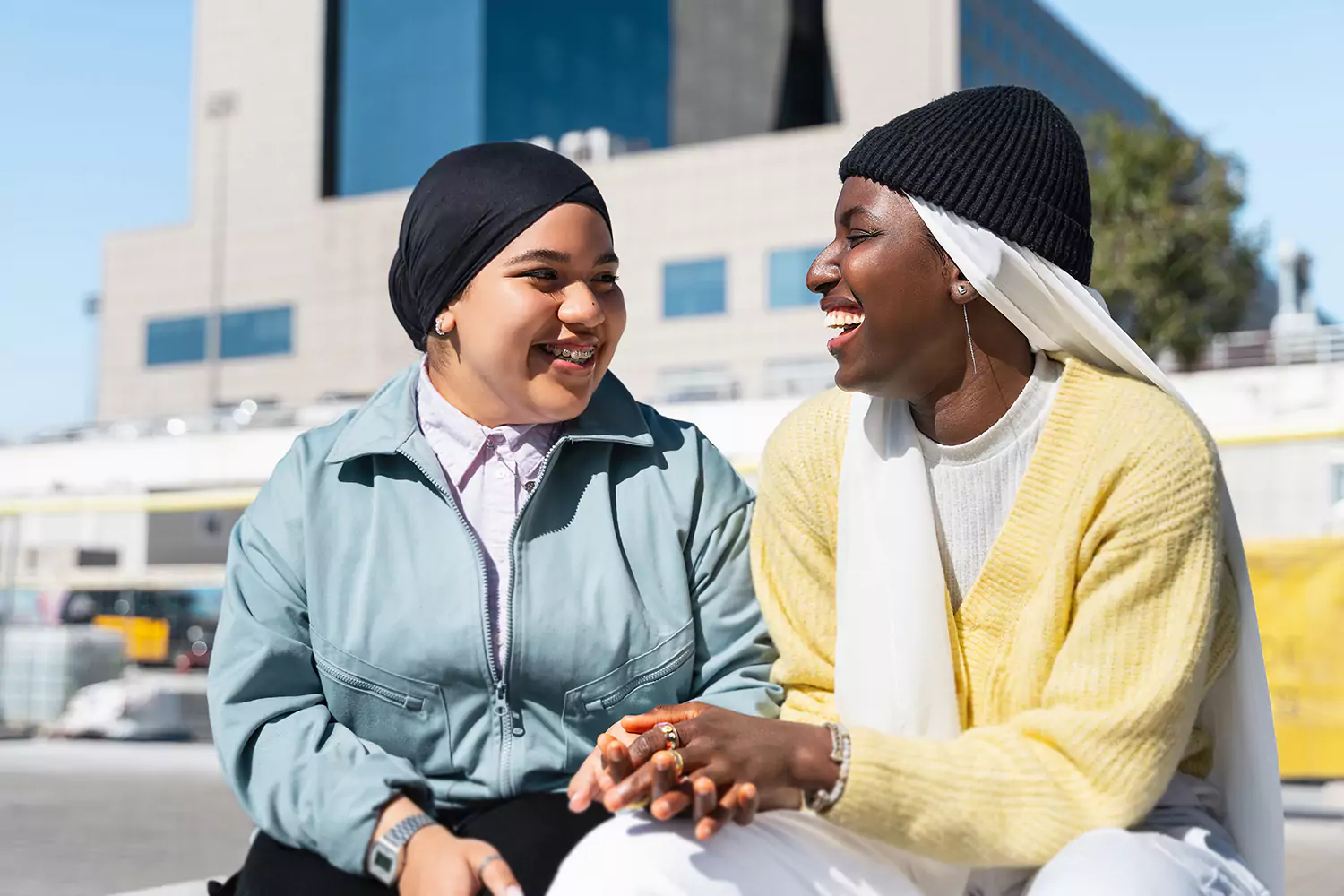 Two woman are laughing together while outdoors